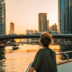 Guest on a yacht at sunset with the city skyline