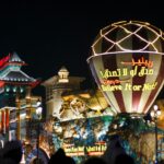 Lit-up entrance with crowds at night