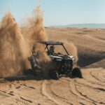 Person driving a buggy on the desert