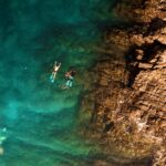 Swimmers in clear blue water