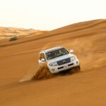 White 4x4 on the red sand dunes