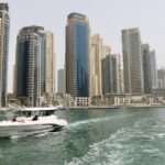 White yacht near the Dubai Marina towers